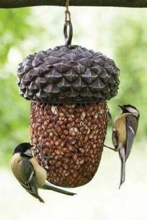 Normally acorns are food for birds and squirrels. Now this acorn feeder is holding other food. The bird feeder can be filled with peanuts and nuts.  Looks good hanging in the garden and perfect for bird watching,  By loosening the suspension ring you can take of the lid and easily refill the bottom part with feed.